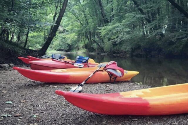 Kayaks Sitting Next To A River
