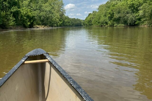 Canoe Flowing Downriver