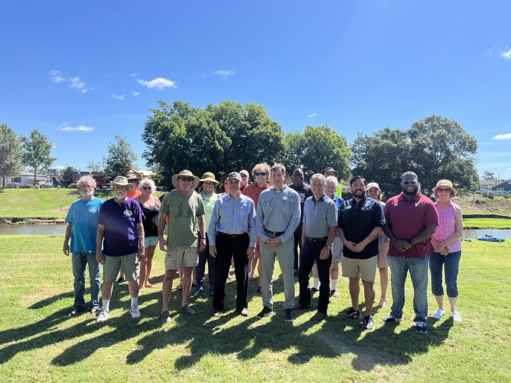 A Crowd Gathered In Front Of Autauga Creek