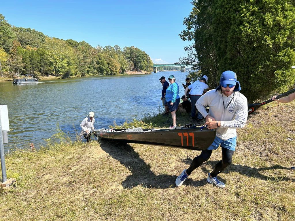 A Group Of People Standing Next To A Lake